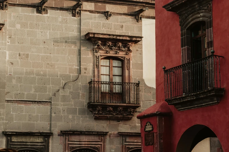 an old building with a clock and balcony