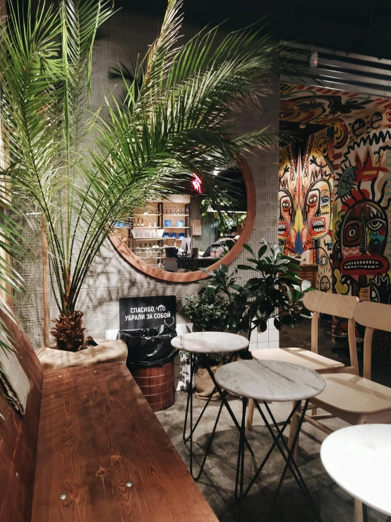 a small cafe with wooden tables and white chairs