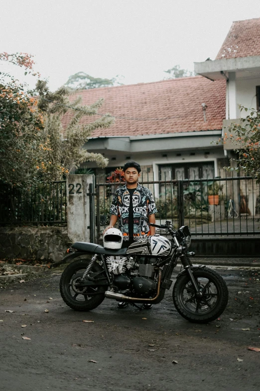 two people sitting on a motorcycle that is parked in the street