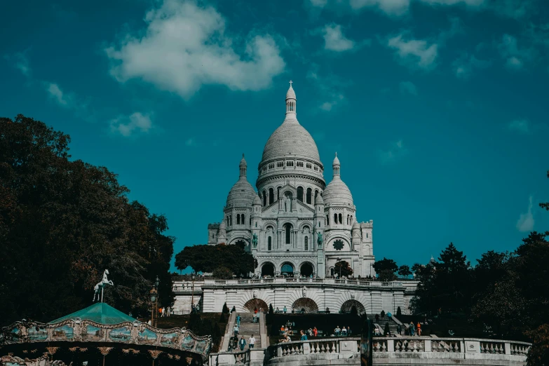 a cathedral stands next to some trees