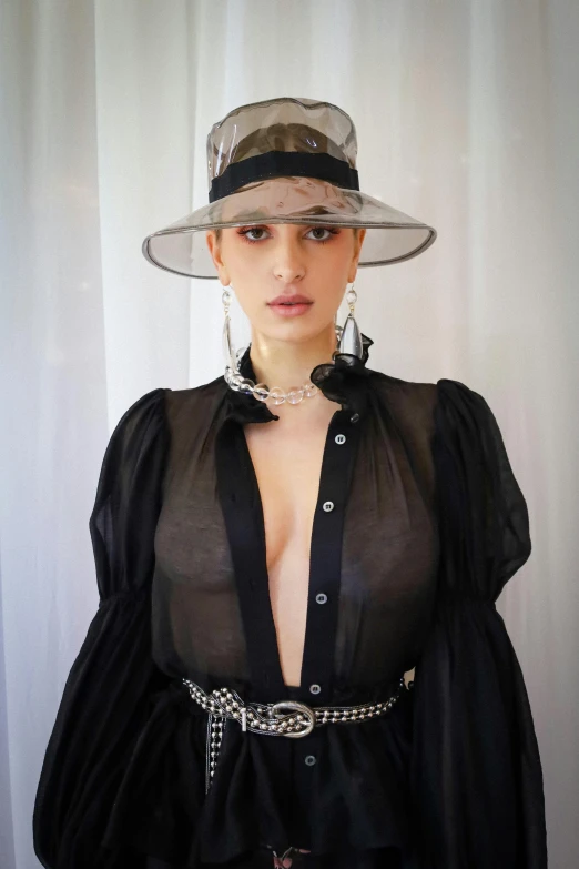 a woman in a very cute black dress with some big hats