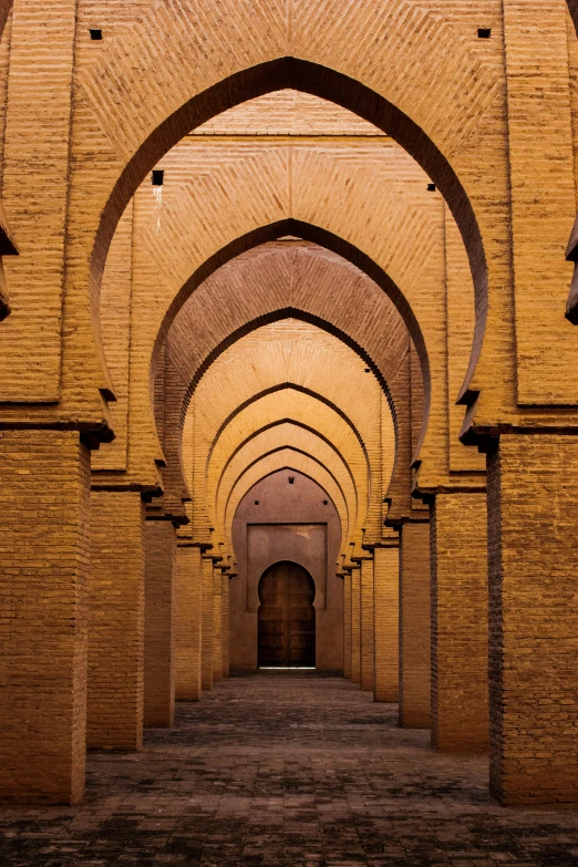 a very long hallway is filled with columns