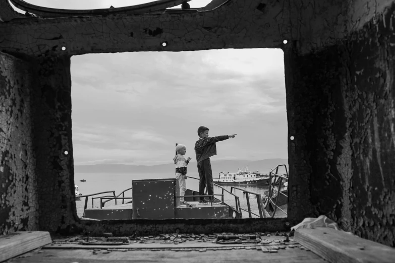 a man standing on top of a cement structure pointing at soing