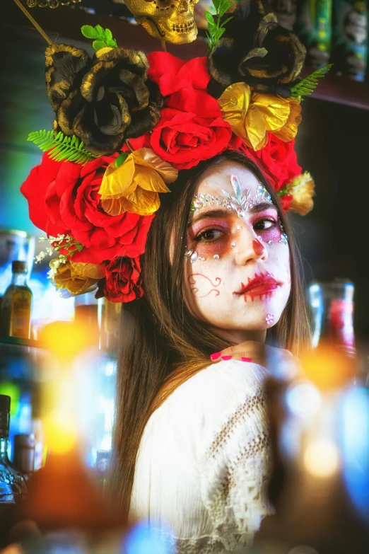 a woman with white face paint in a floral crown