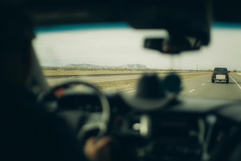 a car view from the inside looking at a highway