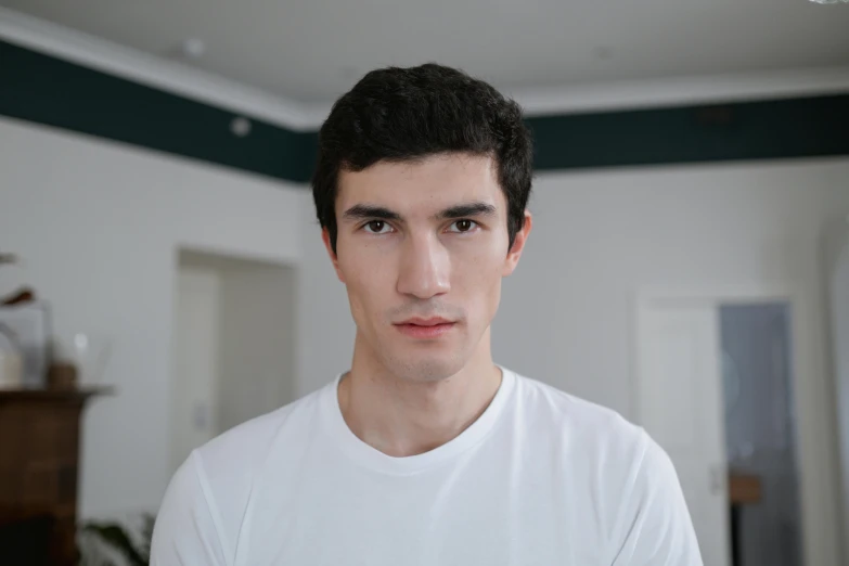 a young man looks into the camera as he looks off