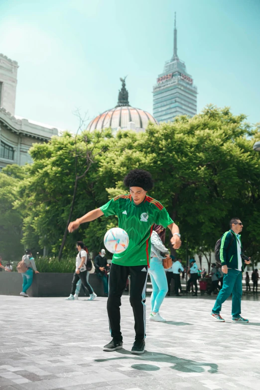 people playing soccer in front of a tall building