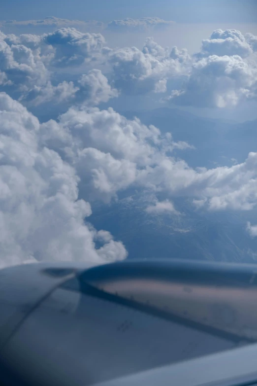 the view from an airplane shows the wing and the clouds