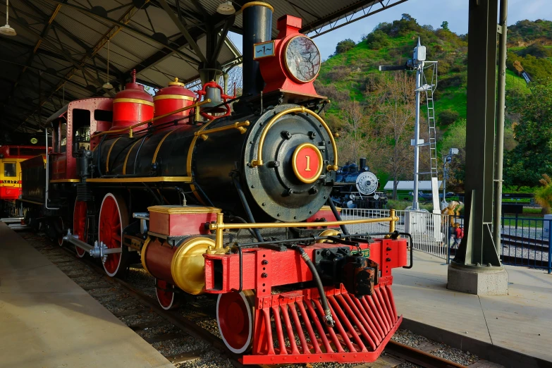 an old steam train stopped at the station