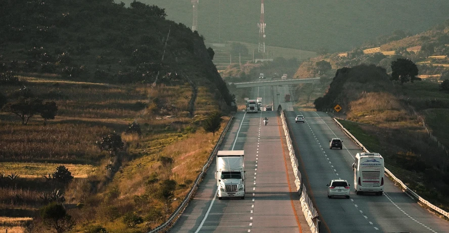 a long stretch of highway with trees on both sides