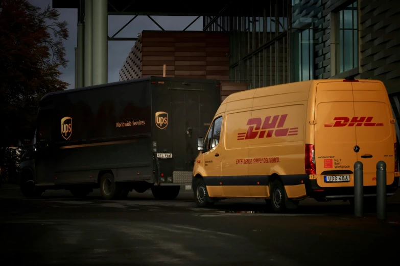 two delivery trucks parked near each other in a parking lot