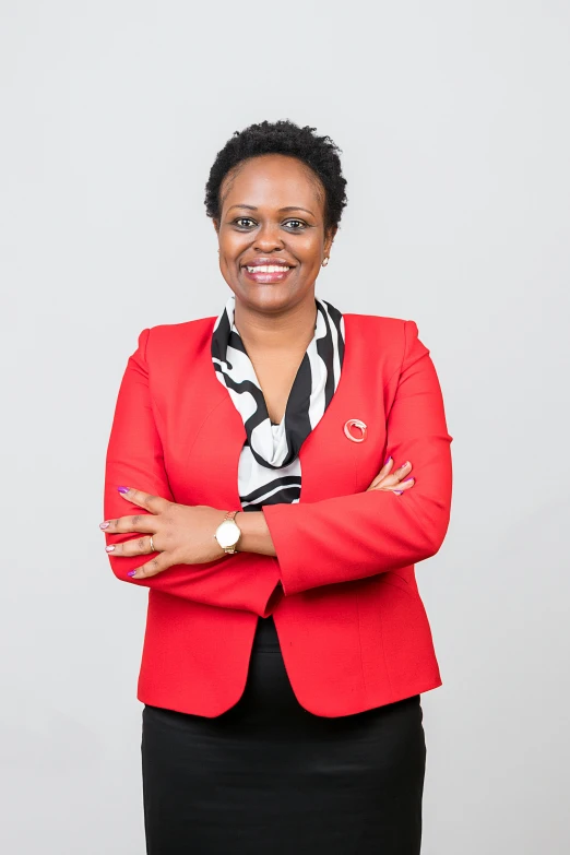 a woman in a red jacket and striped scarf