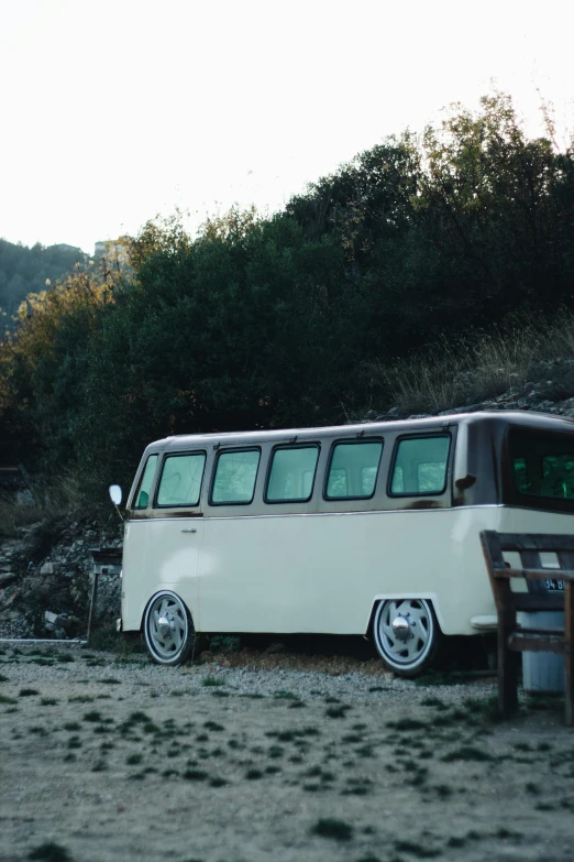 an old van is sitting in the middle of some grass