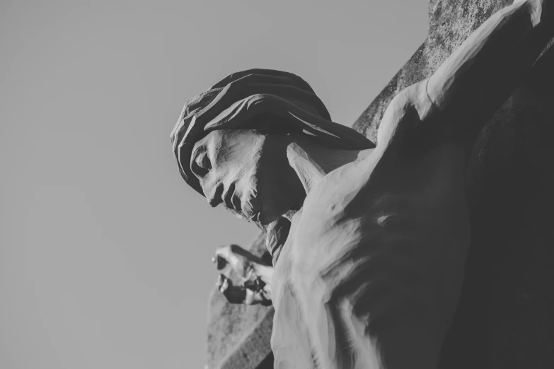 black and white image of the statue in front of the top of a building