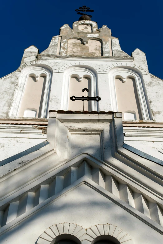 a tall white building with a bell on top