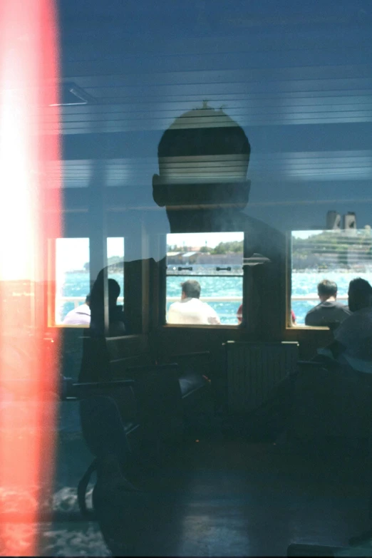 people sitting on chairs in front of the open train window