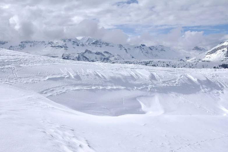 a pair of people riding skis down a snow covered slope