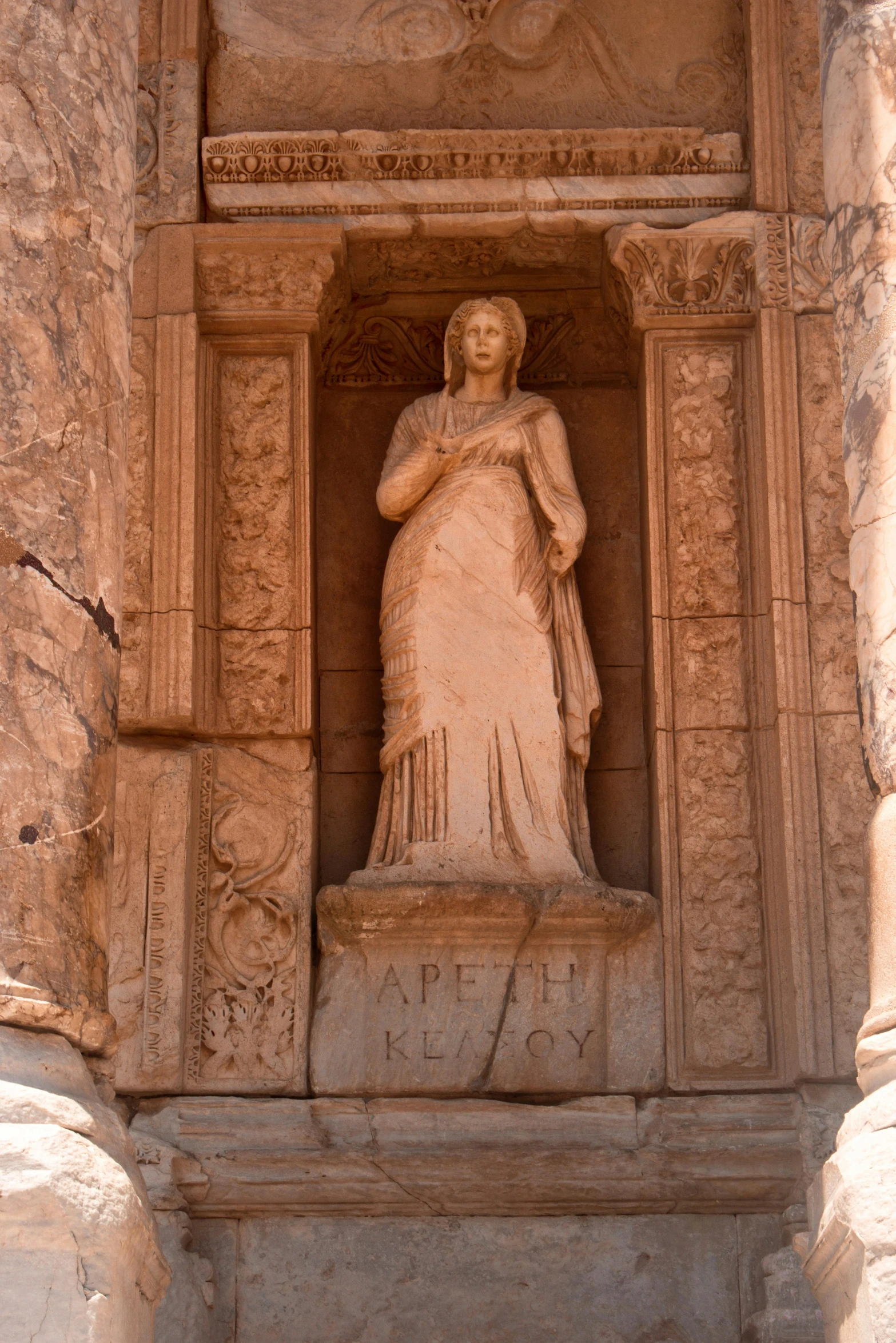 a tall statue with a woman at the base of it