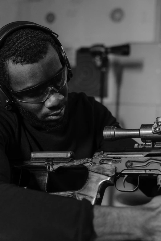 a man wearing headphones with a rifle in hand