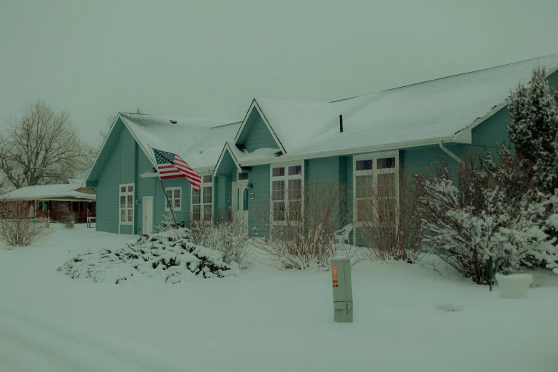 a snow covered front yard area of a home in winter