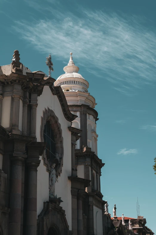 a very tall church with a large dome and statues