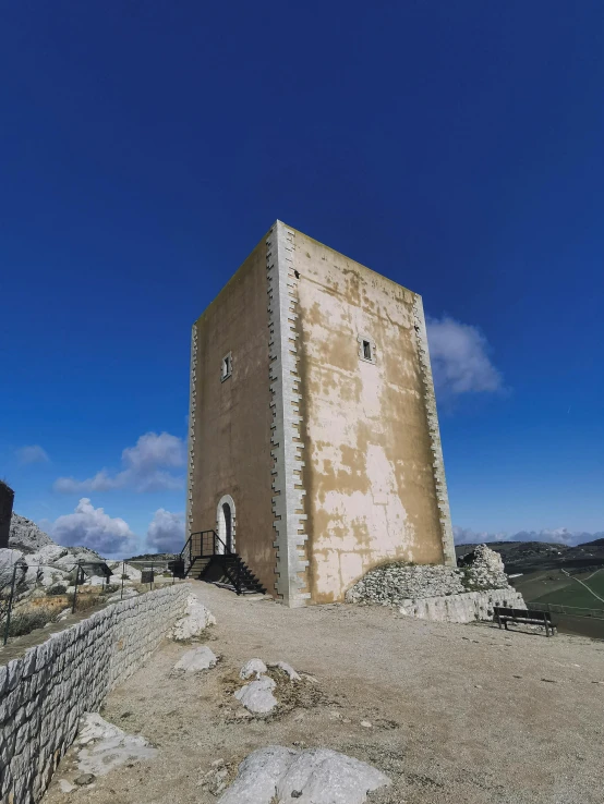 this old structure is standing on a hill near the ocean