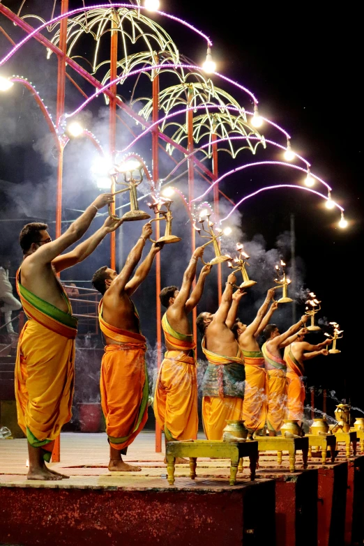 various dancers performing on stage near a tent