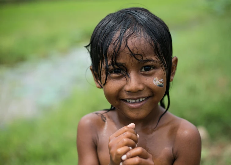 a small child with nose tattoos smiling