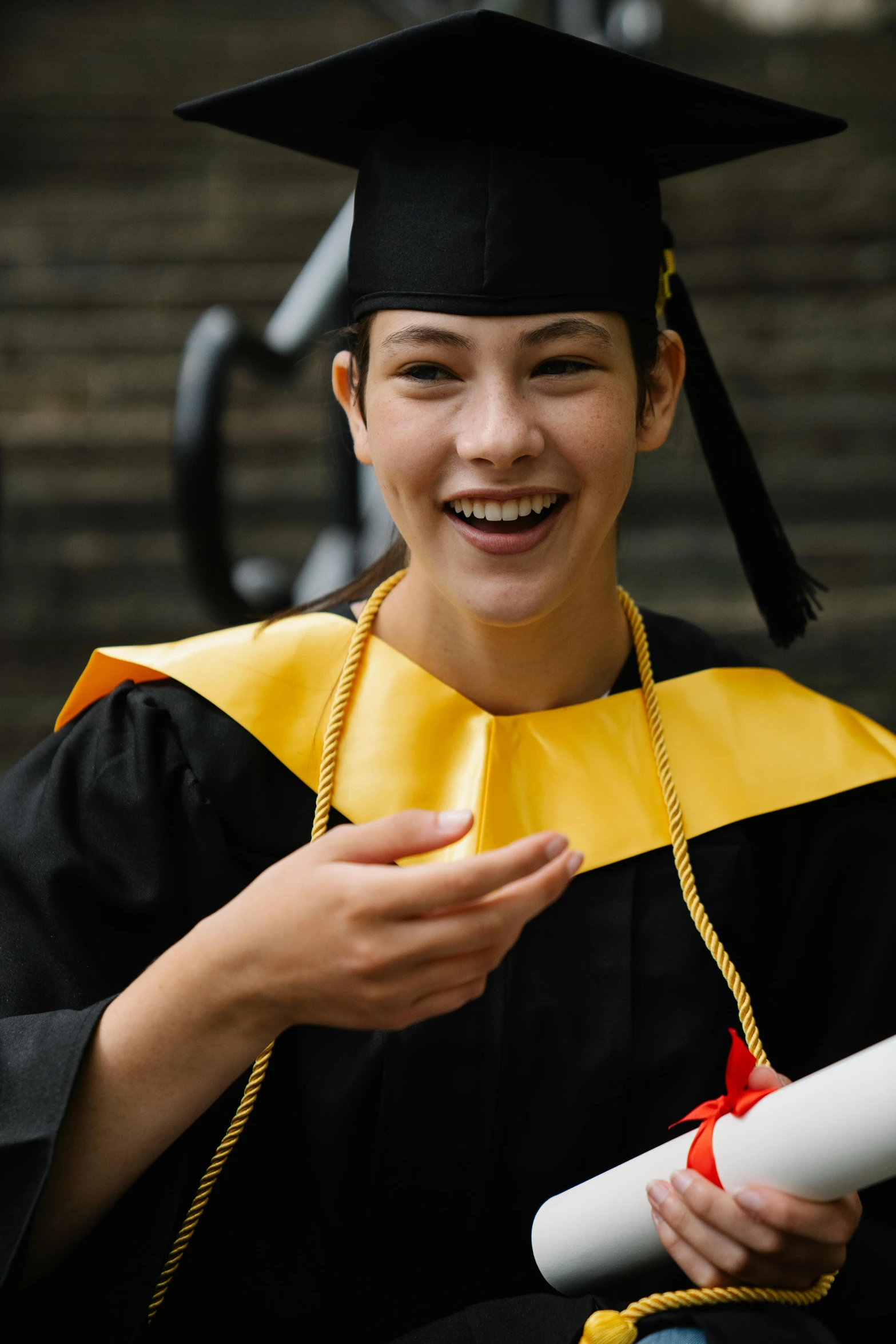 the girl smiles and holds her diploma