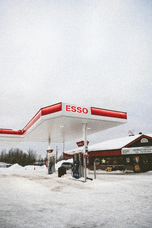 an empty gas station is shown in the snow