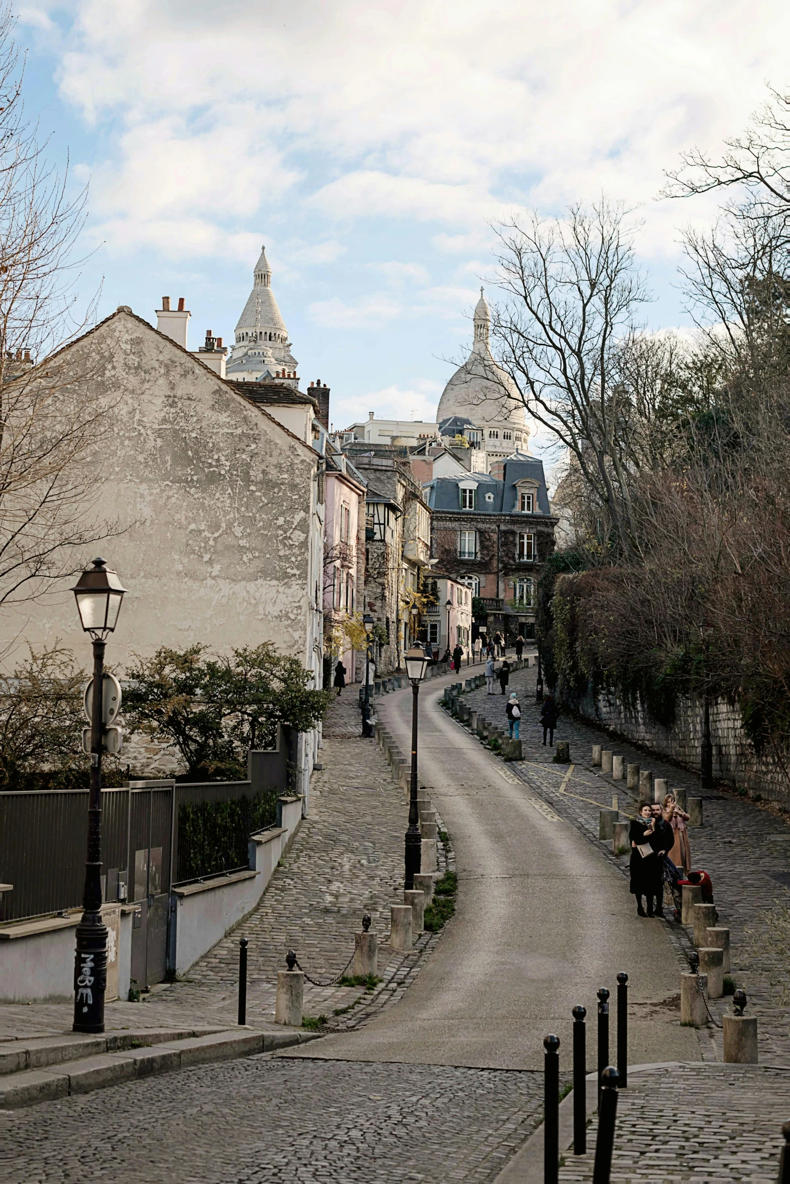 a couple walks down the street near a sidewalk