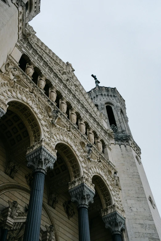 the outside of a stone building with a tall clock tower on it