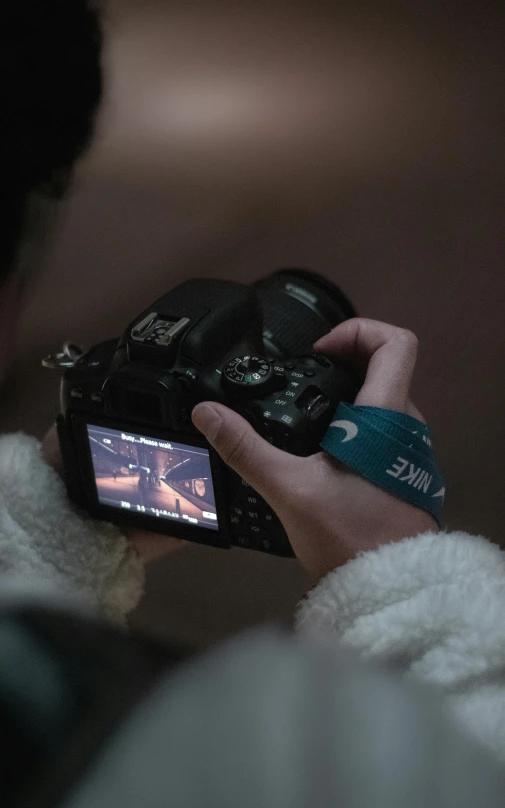 a person is holding a camera in their hand