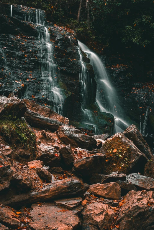 a waterfall that has falling water in the middle of it