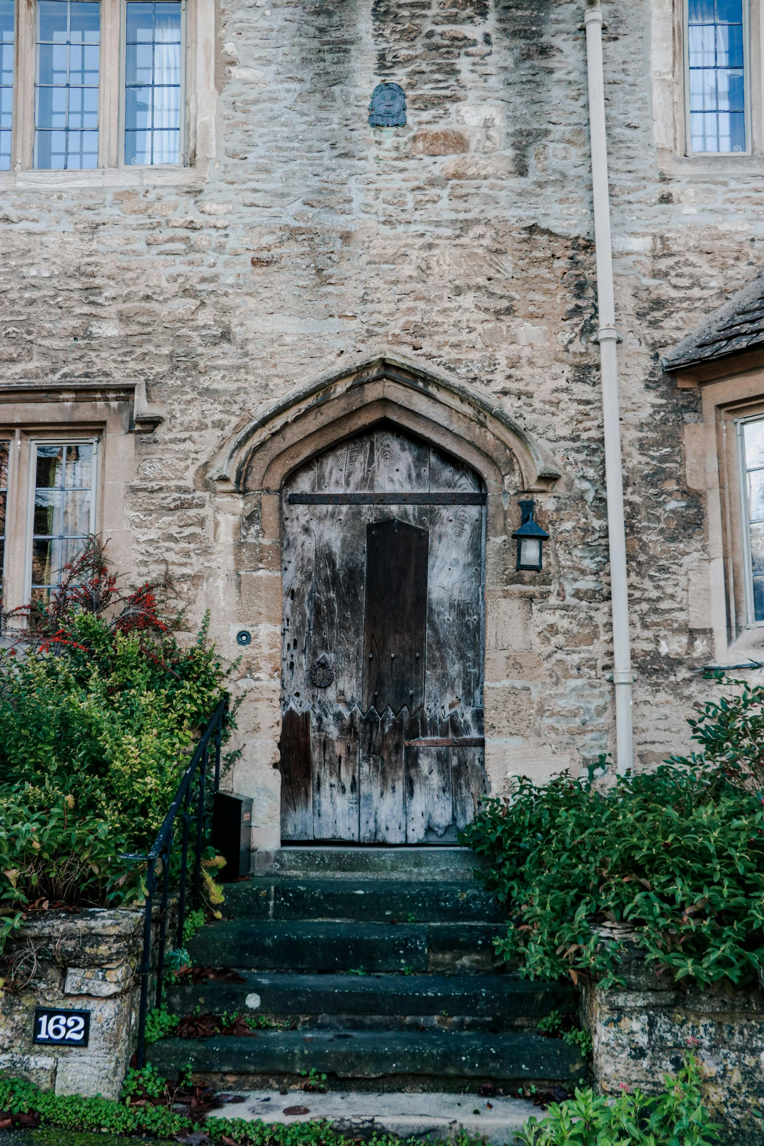 a tall building with a wooden door and a steeple