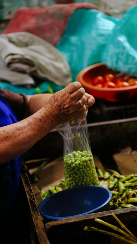 a woman putting food into a plastic bag