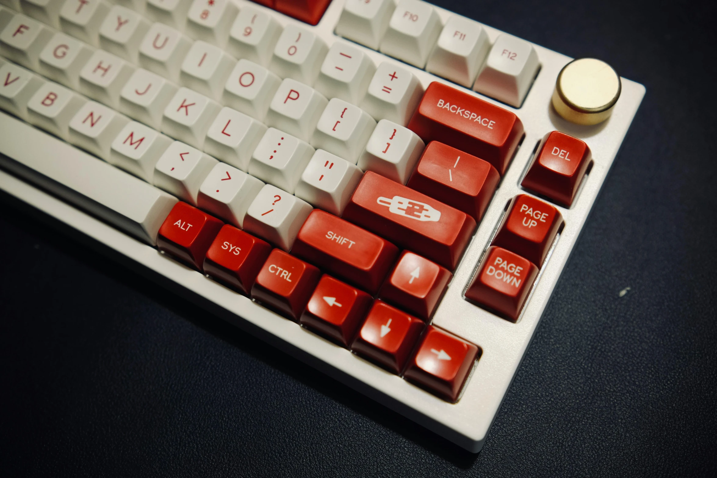 a red computer keyboard that is placed on a black table