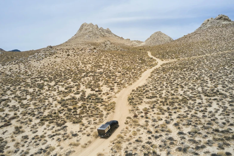 a truck driving in the middle of a desert