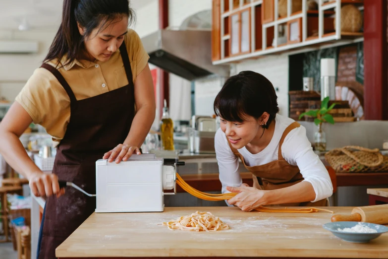 two asian women in the kitchen  a pasta