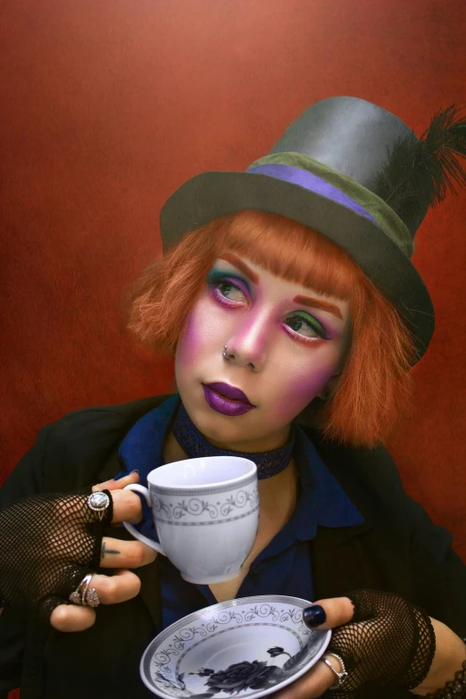 a red haired woman holding a coffee cup in her hands