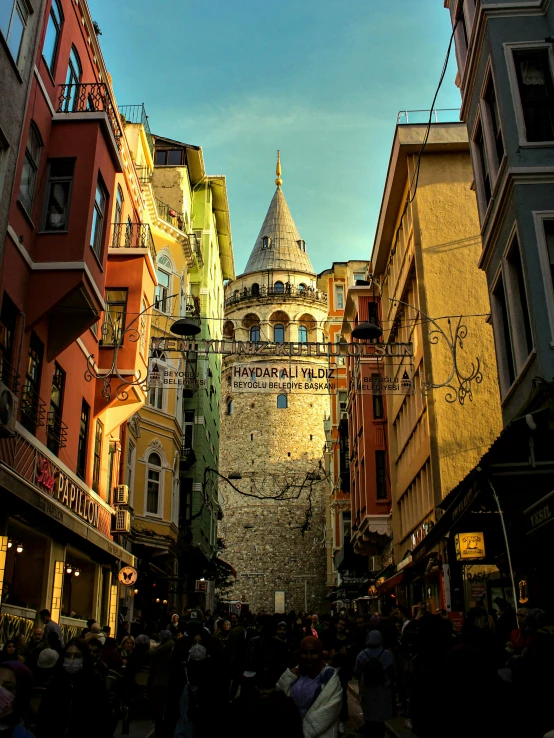 several people walk around on an alleyway in the city