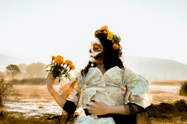 a woman with a skeleton face holding flowers in front of her