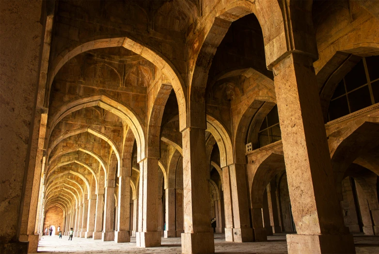 a large room with columns and arches