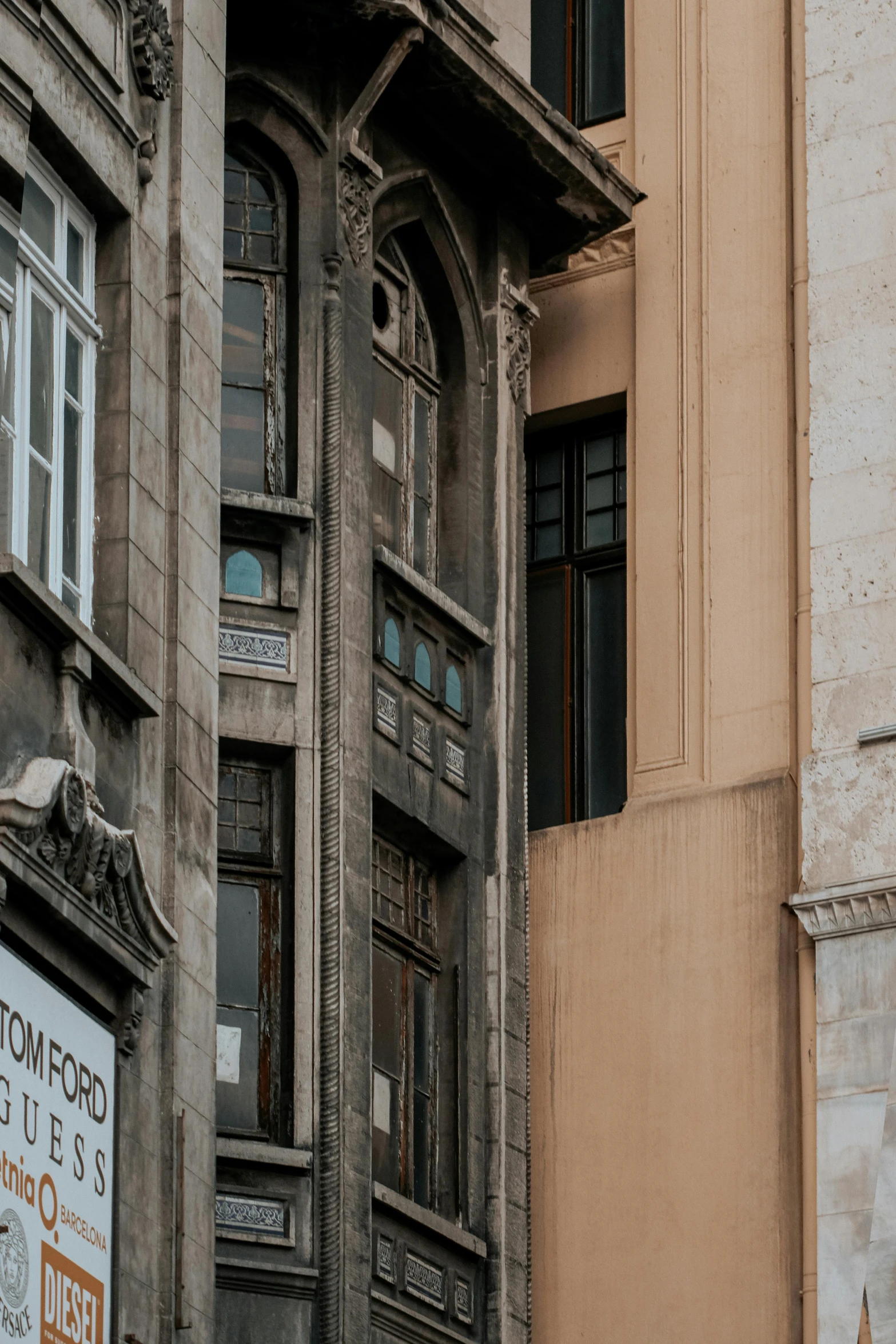 an old building has a clock on the corner