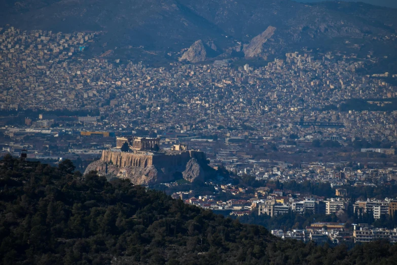 an aerial s of a city and a castle with the mountains in the background