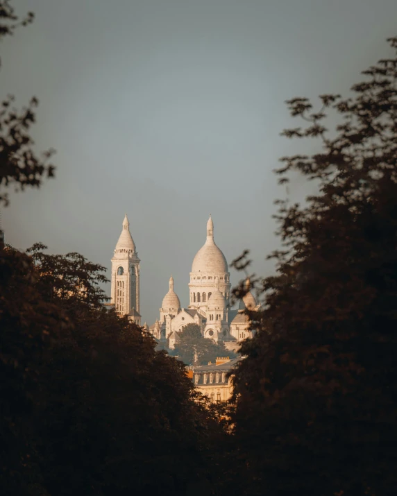 the building is on top of a mountain near many trees