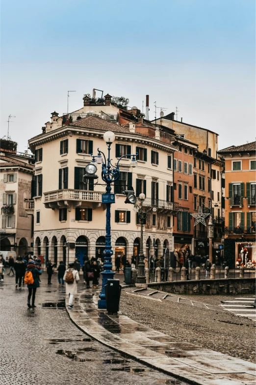 people are walking near a busy street near many buildings