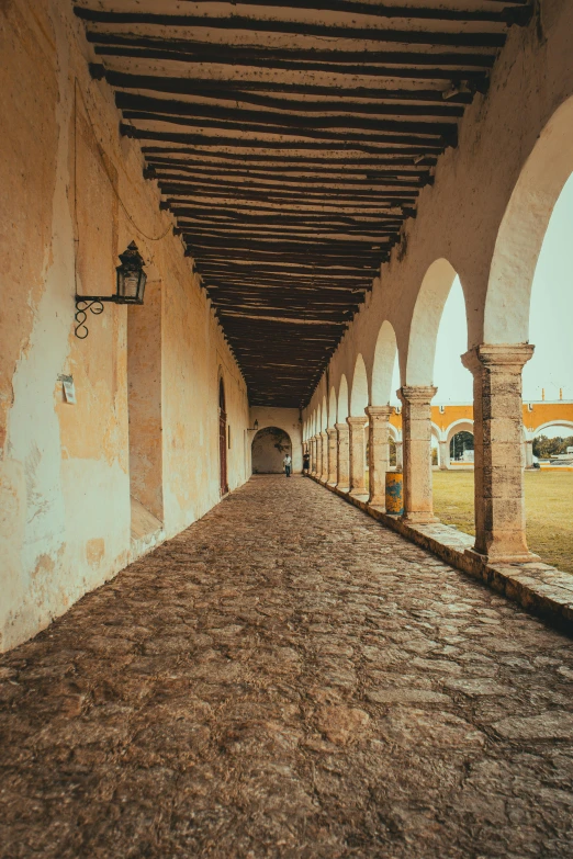 an empty, large walkway between two large building