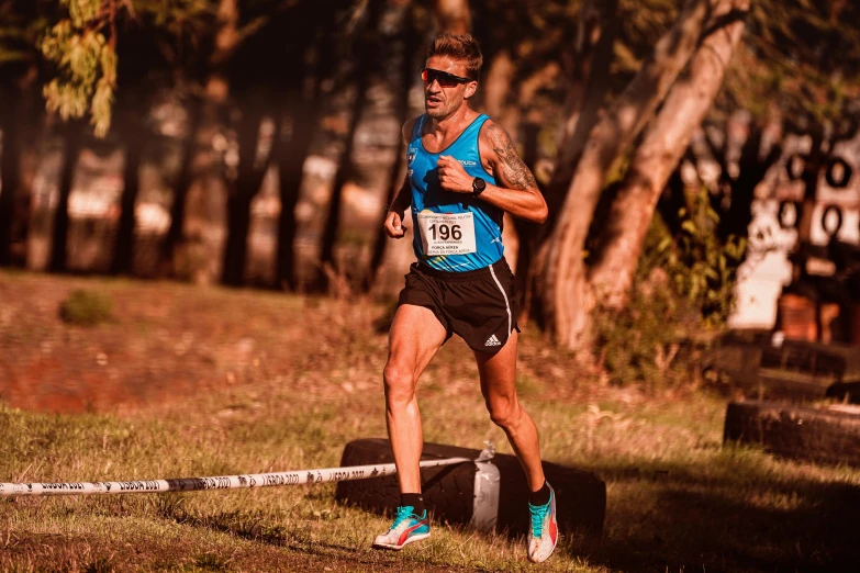 an older man running a race with a backpack