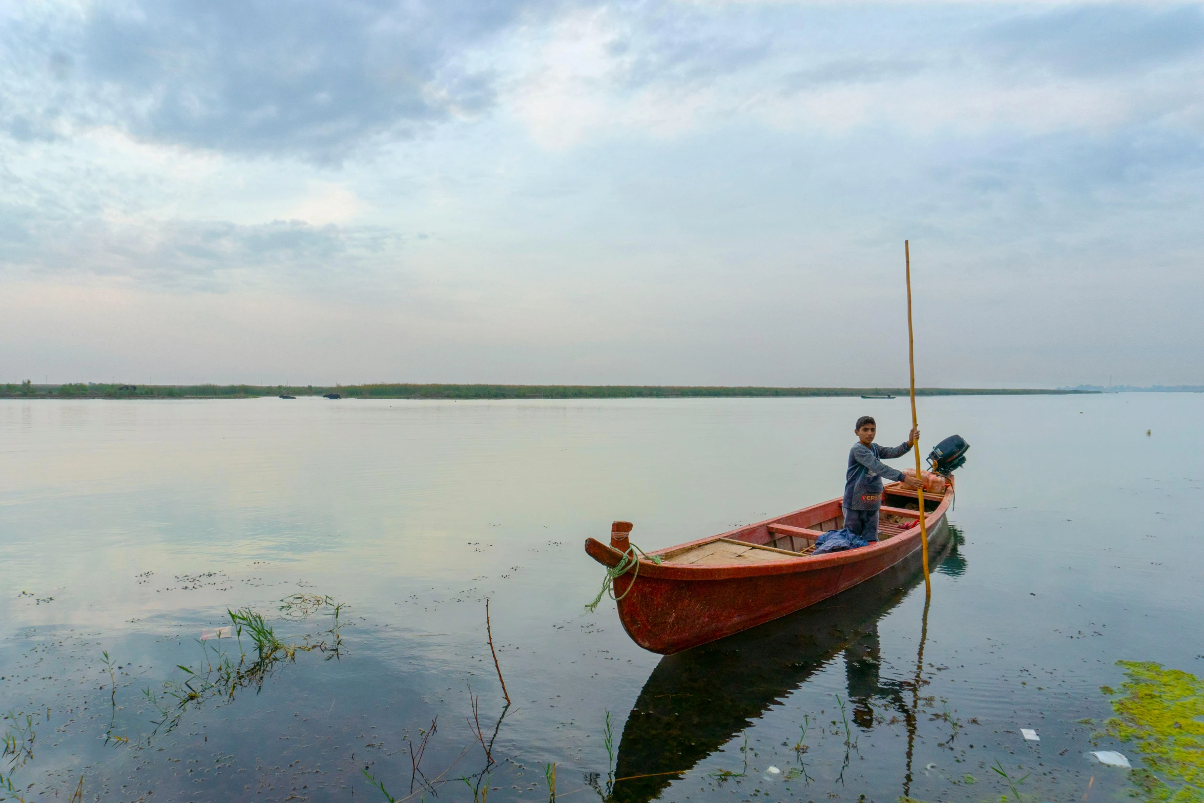 two people in a small boat on a lake